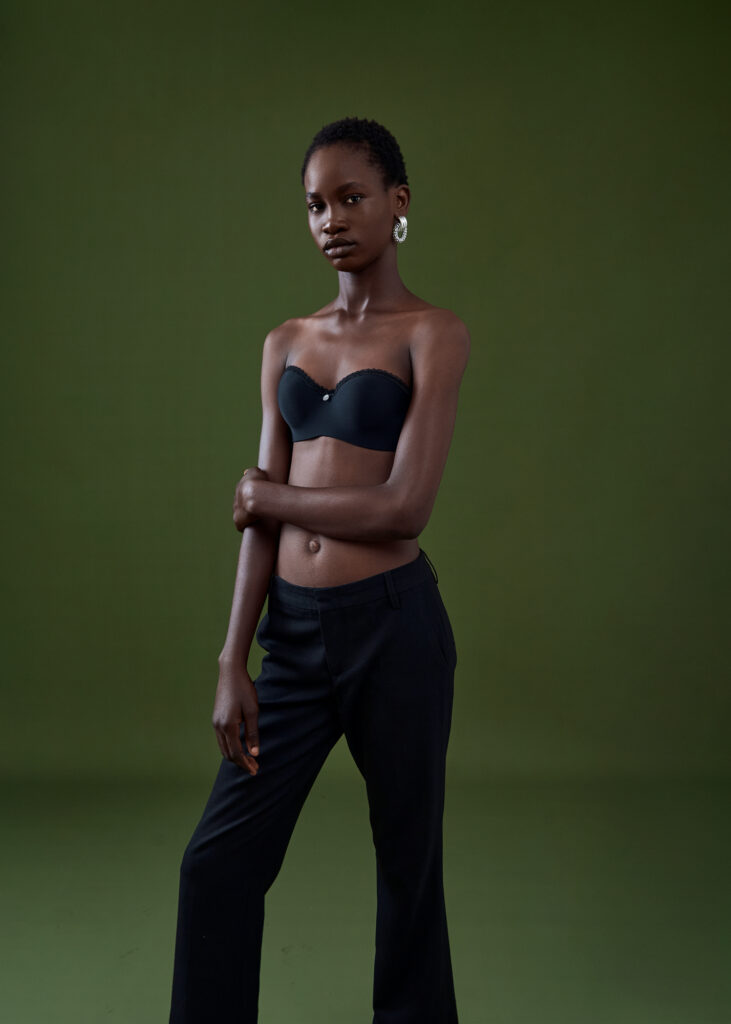 a black female model wearing a bralette and leggings