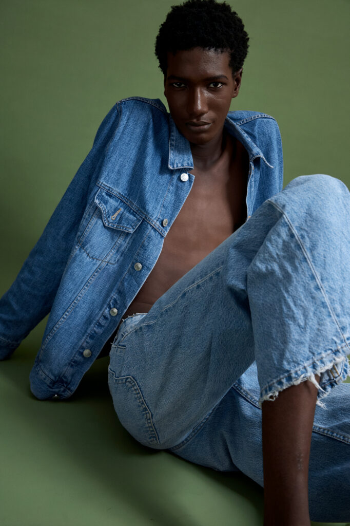 a black male model sited on the floor