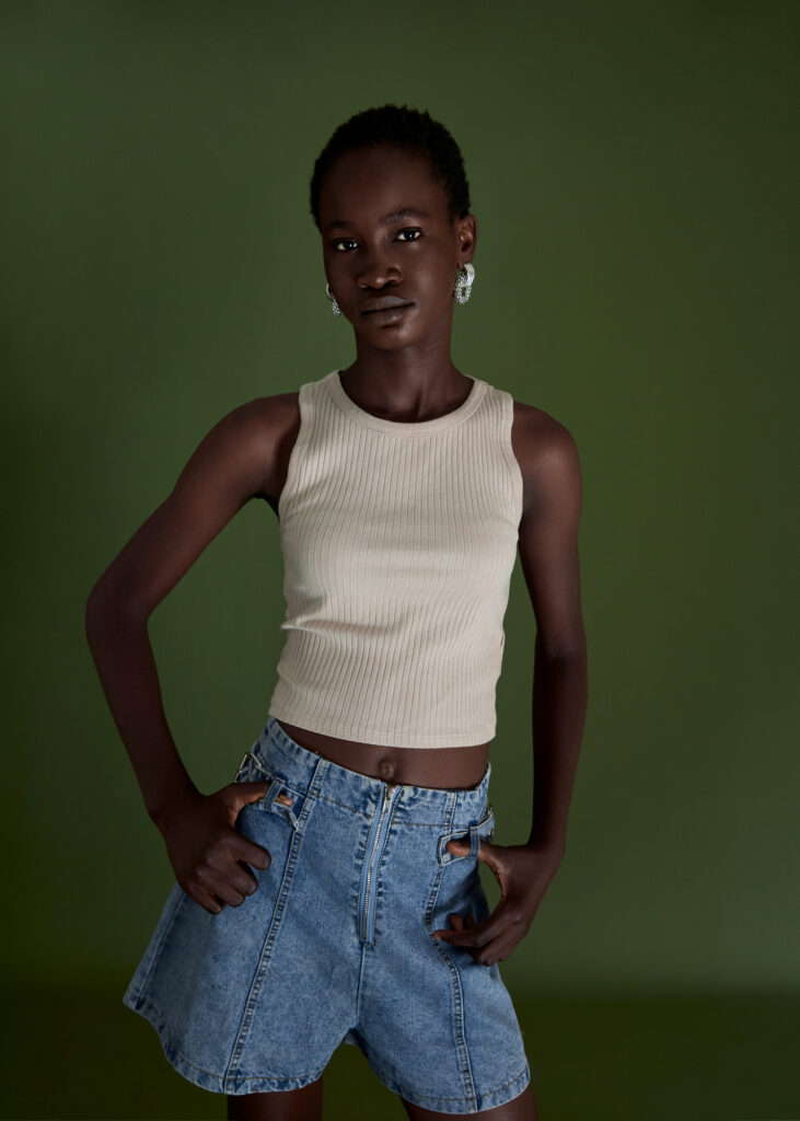 a black female model wearing a tank top and kean shorts